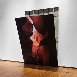 Letha Wilson, Slit Slot Canyon, 2023, 12' x 9.5' hole, 12' x 9.5' drywall and metal stud wall with pigment print, and cut
