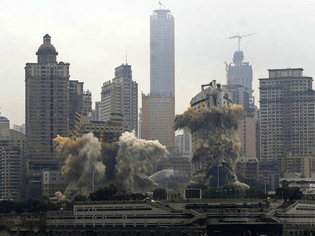 the-three-gorges-hotel-and-chongqing-ports-passenger-terminal-come-down-as-part-of-a-controlled-demolition-in-chongqing-chin...