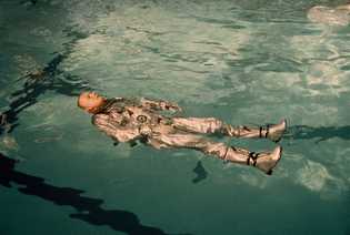 Astronaut Neil Armstrong floats in his space suit in a pool of water in 1967, photograph by NASA