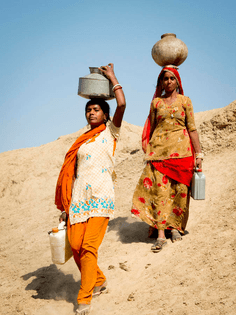 women-carrying-water-head-jaisalmer-india-march-close-up-portrait-two-desert-march-jaisalmer-india-walking-30631615.jpg