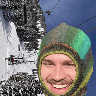 Man wearing knit balaclava over an image of a ski mountain.