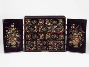 Japanned cabinet, English or Dutch, late 17th century, two doors enclosing drawers, polychrome decoration of vases and flowers on a black ground