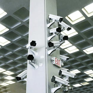 Surveillance cameras on building pole