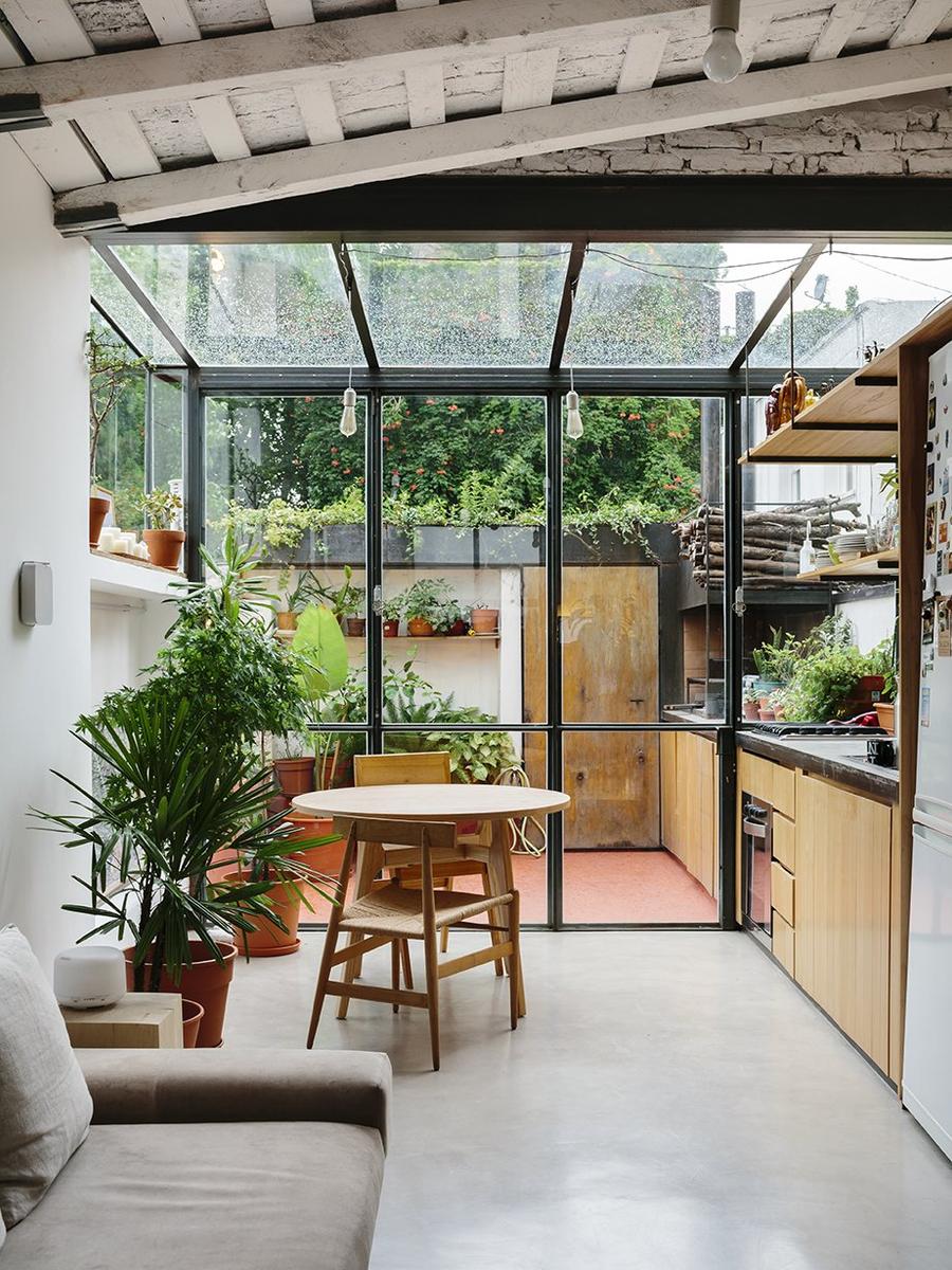 a-steel-and-glass-structure-wraps-one-end-of-the-apartment-adding-the-illusion-of-greater-space-to-the-720-square-foot-home-...